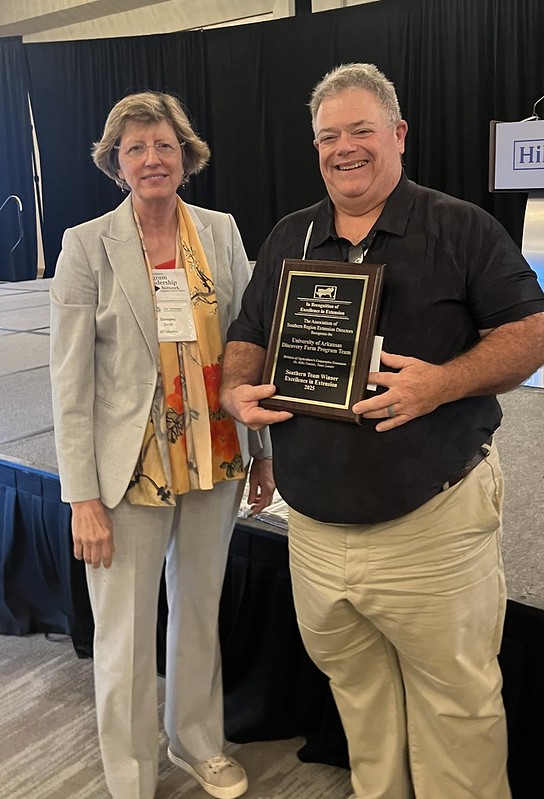 Mike Daniels accepts the Excellence in Extension Team Award from Damona Doye, chair of the Association of Southern Region Extension Directors, on Aug. 19, 2025, in Atlanta.