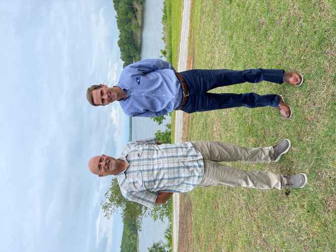 2 men standing on top of grass