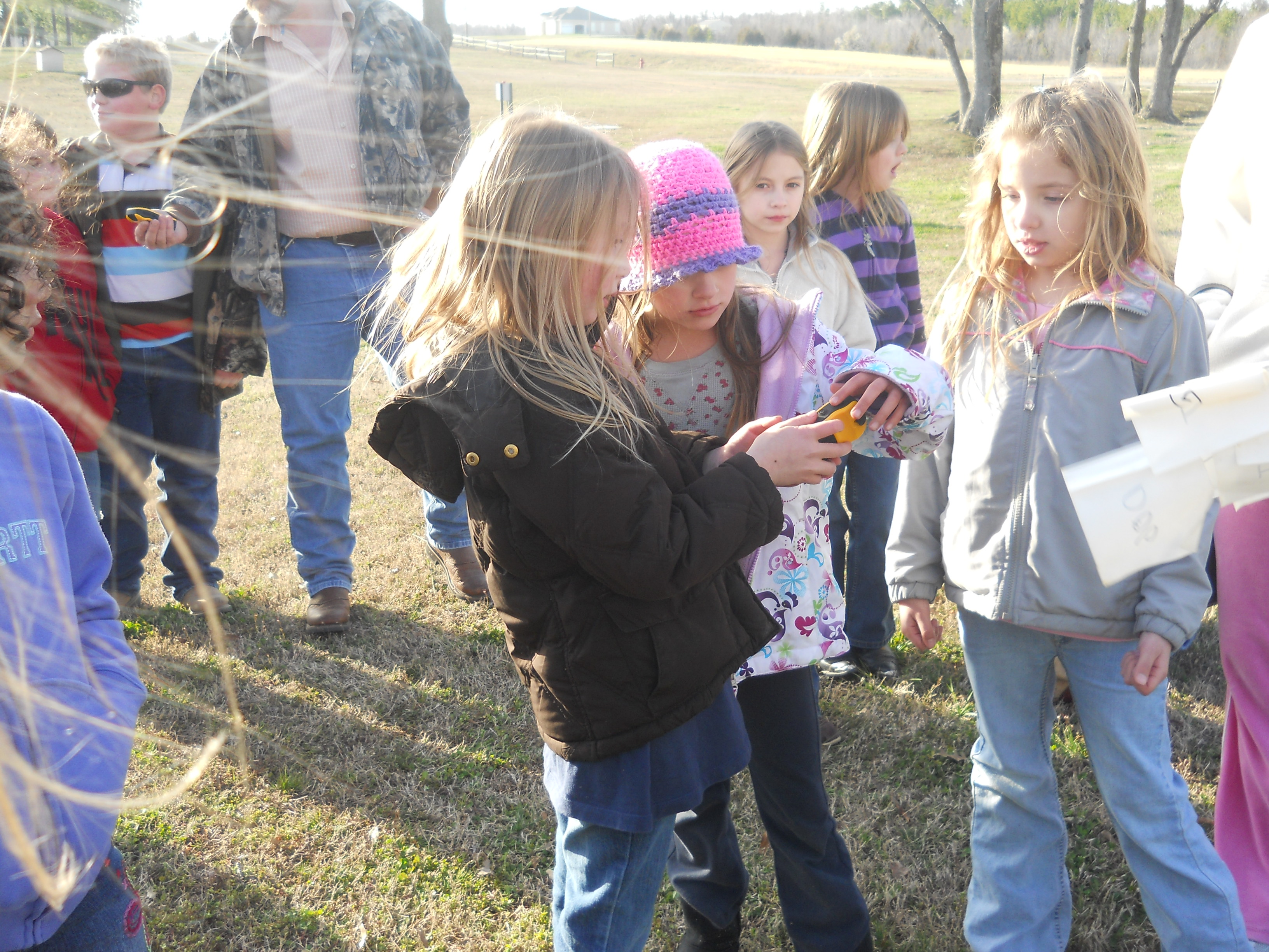Clay County youth learning how to use hand held GPS unit