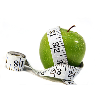 Freshly rinsed green apple with tape measure draped around