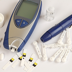 Collection of devices used for blood sugar testing – glucometer, glucose test strips, lancet, lancet refills, insulin vial