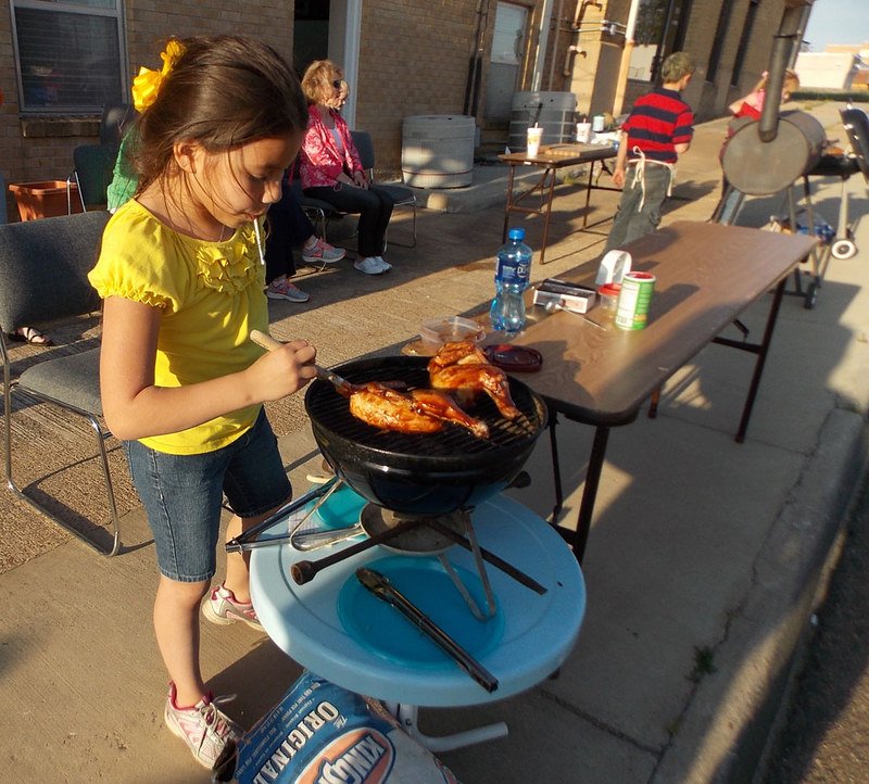 Girl grilling chicken 