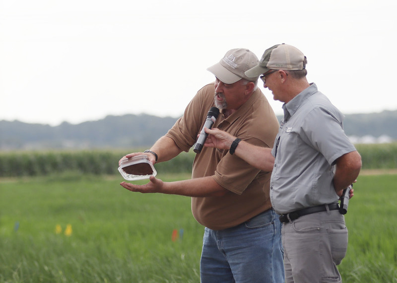 Kris Brye shows a sample of highly compacted soil. 