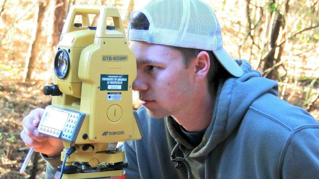 Student using surveying equipment