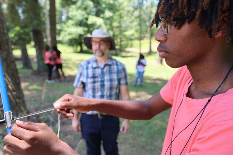 Camp participant conducts activity.