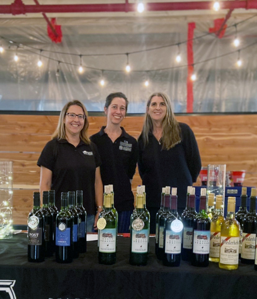 Three wine researchers at a table at a tasting.