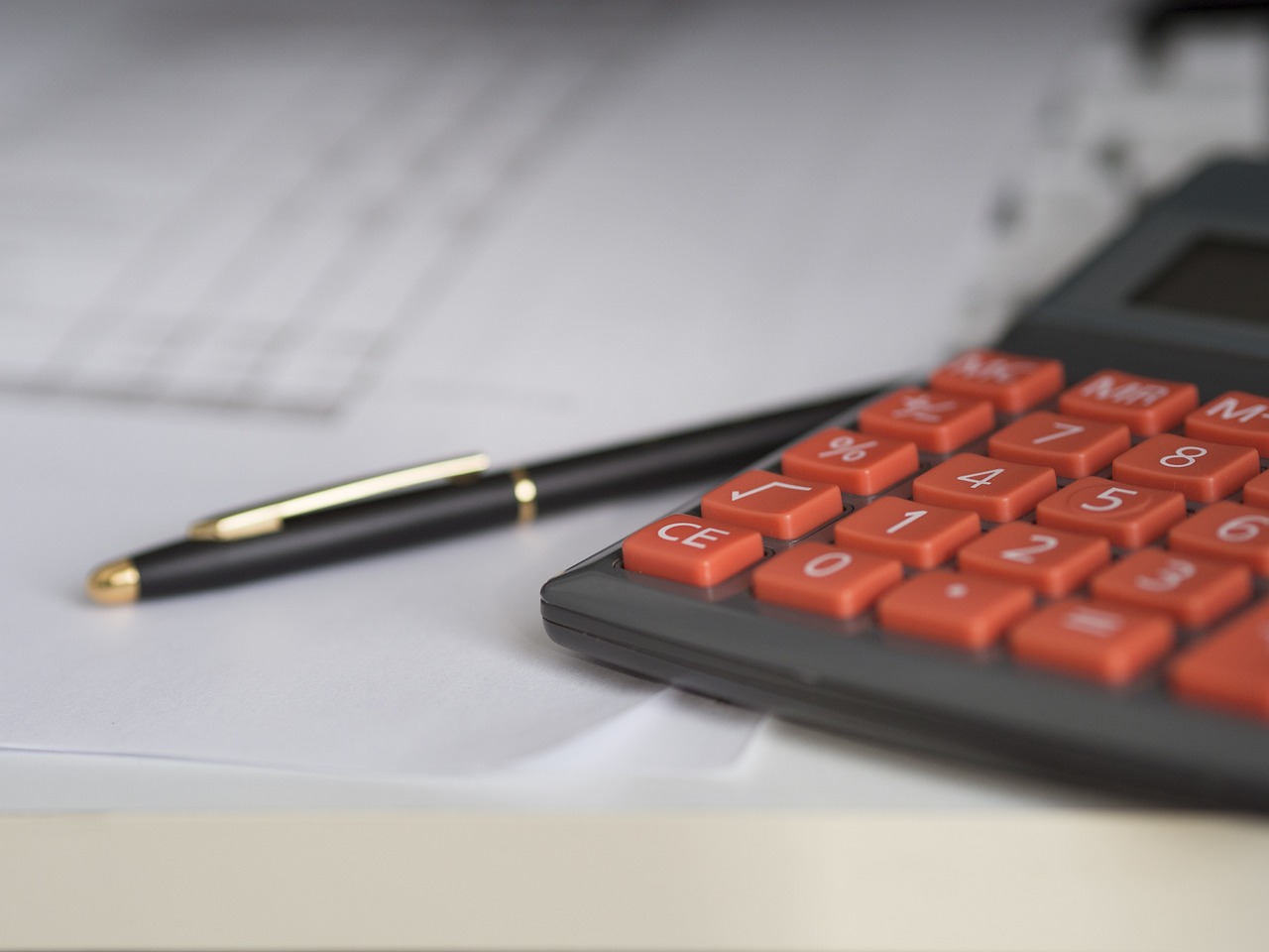 pen and calculator on table