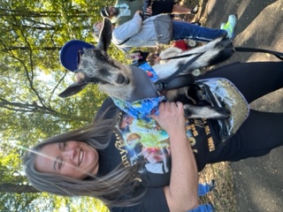 Woman holding a goat.