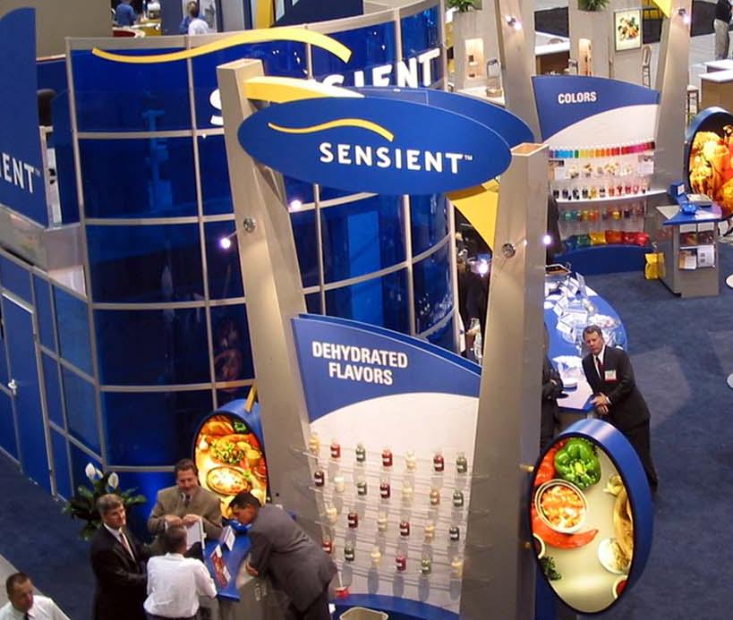 Image of a food expo with vendors and businesses - people walking around