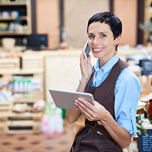 Small business owner taking orders over phone Small Business Owner Taking Phone Order