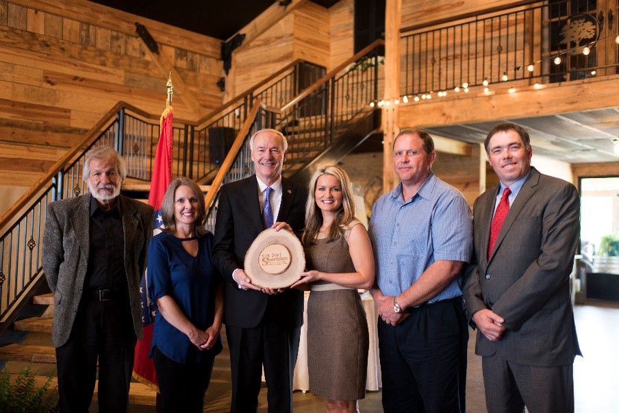 Kick Start Sheridan Executive Team presents Governor Hutchinson with a plaque. Left to right: Sheridan Mayor Joe Wise, Carrie Smith, Governor Hutchinson, Grant County Judge Randy Pruitt, and Grant County Extension Agent Brad McGinley