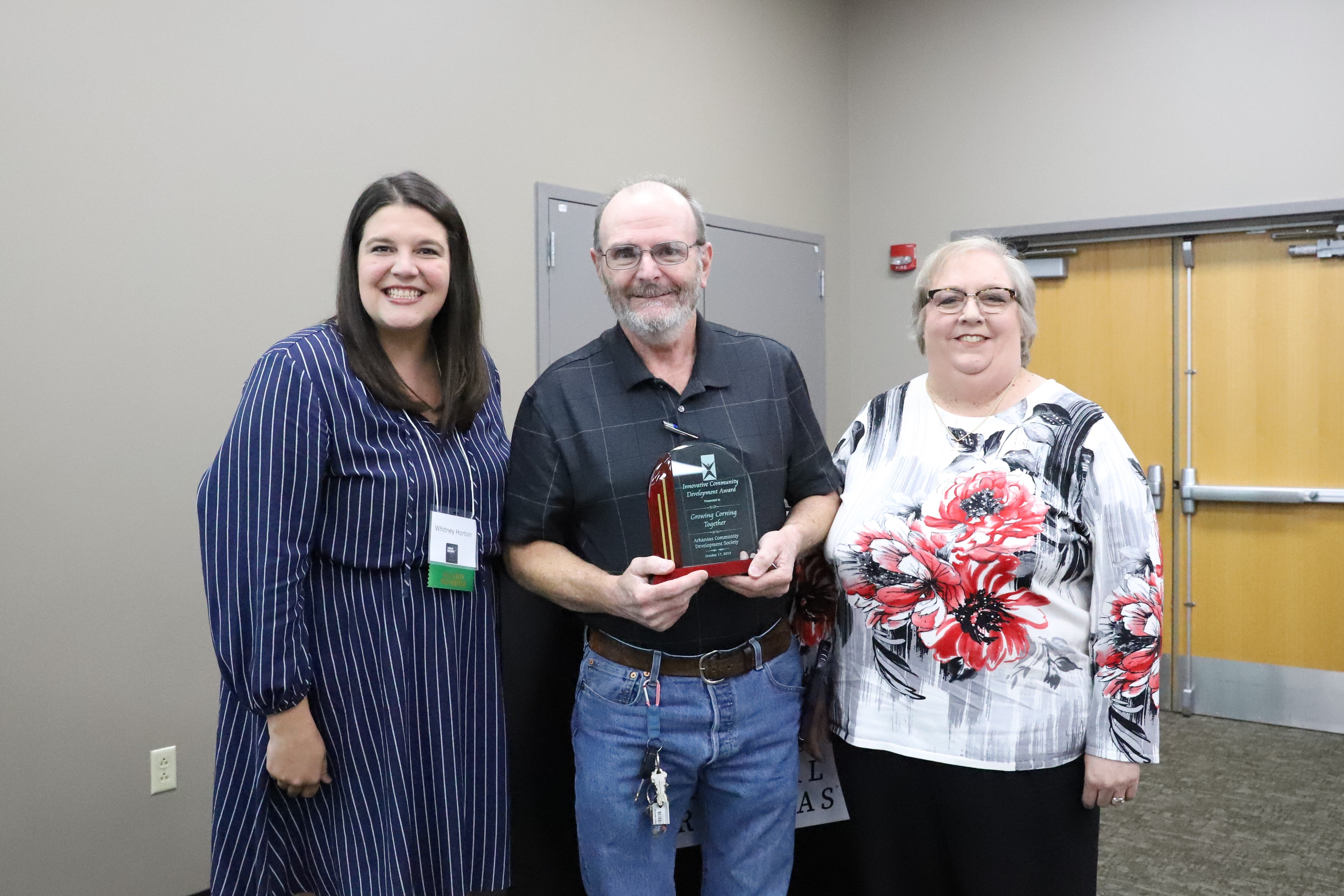 Receiving the Innovative Community Development Award for Growing Corning Together is Bobby and Pam Lowe; presenting the award is Whitney Horton, Vice President of the Arkansas Community Development Society (first on the left).