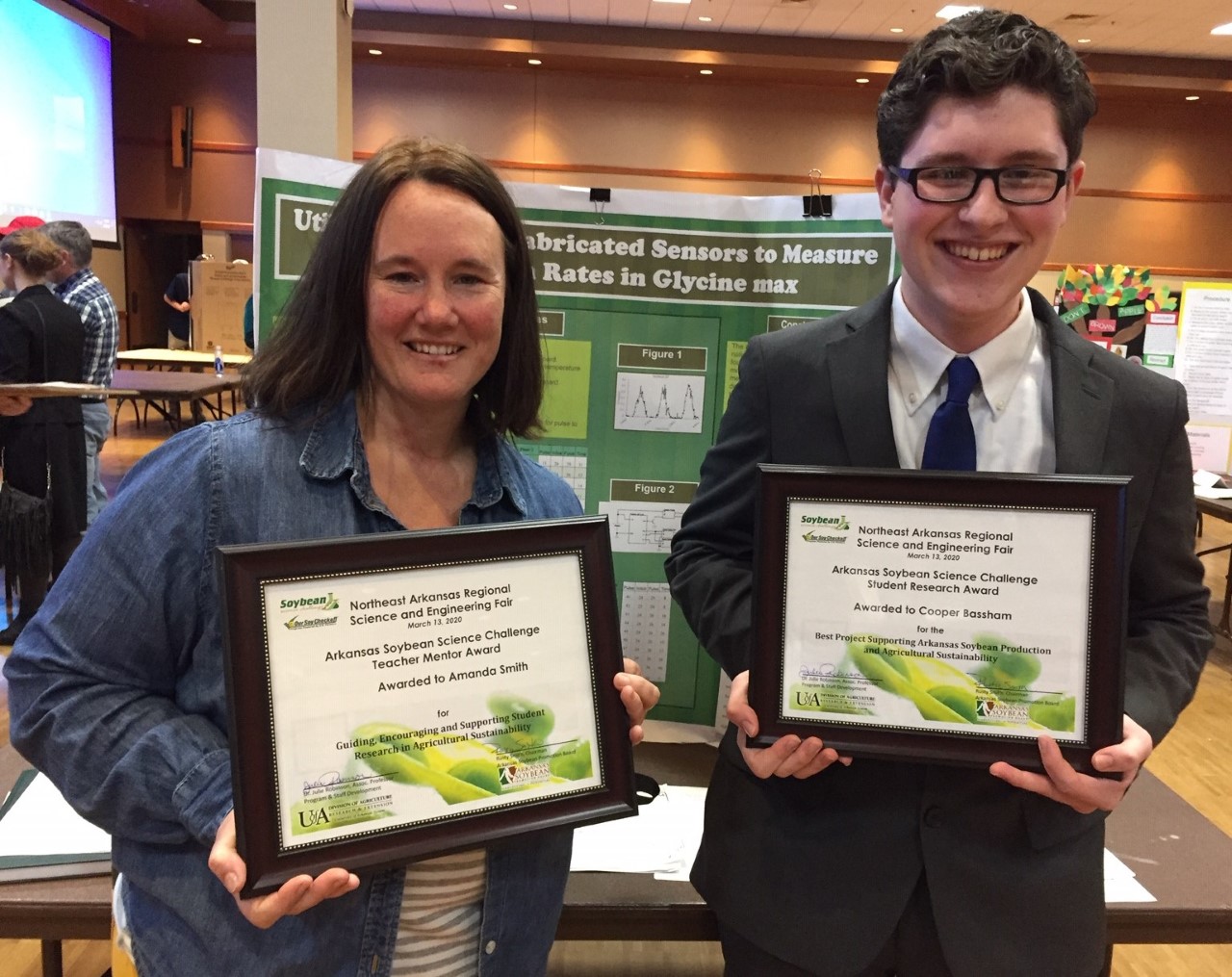 Teacher Amanda Smith stands next to Cooper Bassham, a Soybean Science Challenge Regional Winner, at the 2020 Northeast Arkansas Regional Science Fair. Teacher Amanda Smith stands next to Cooper Bassham, a Soybean Science Challenge Regional Winner, at the 2020 Northeast Arkansas Regional Science Fair.
