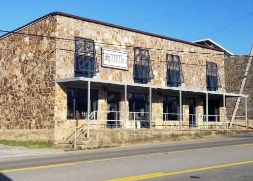 Cobblestone store front with a white sign that says Millie's