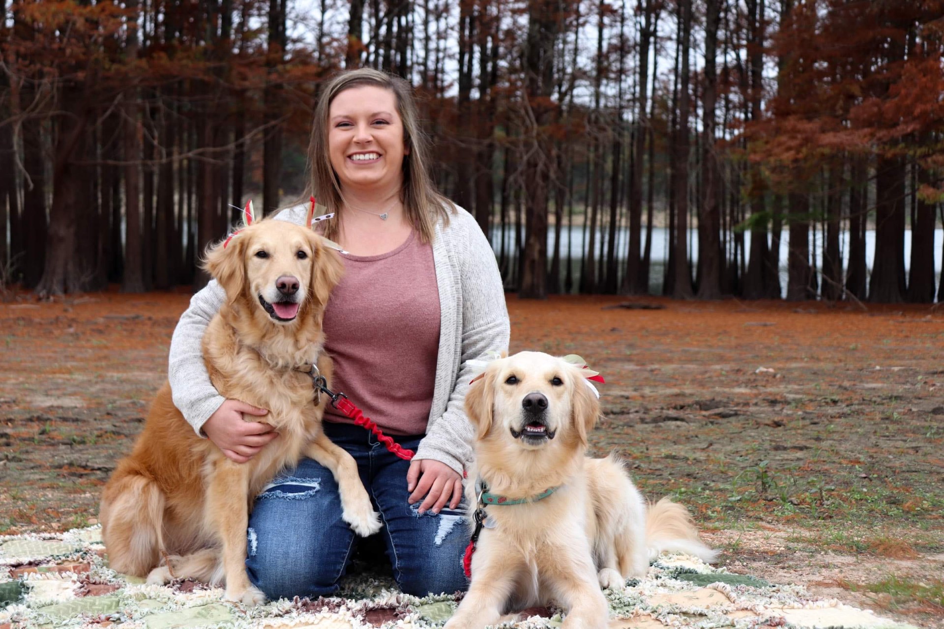 Haley Childers featured with her two golden retrievers