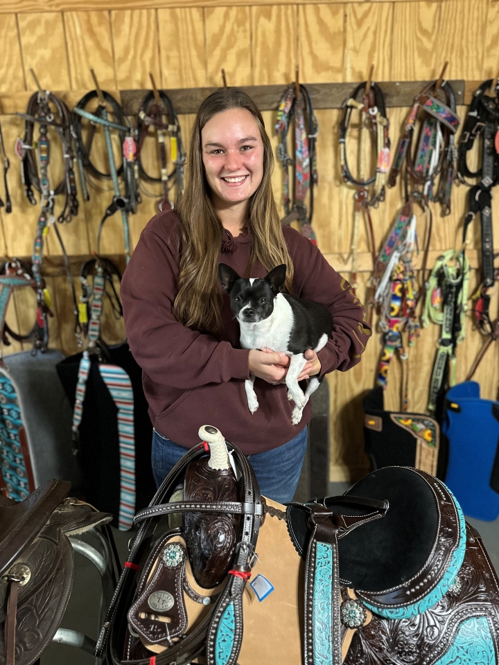 Kayla Lott in her business pictured with her dog.