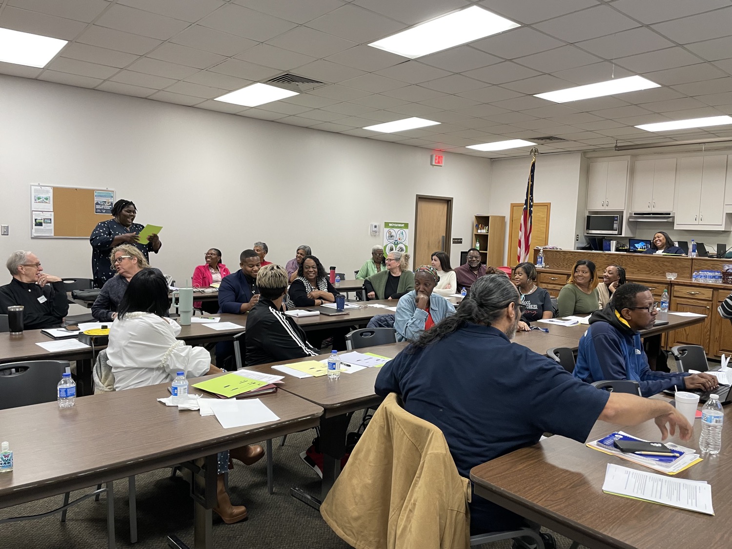 More than a dozen workshop attendees sit at tables during grant writing training