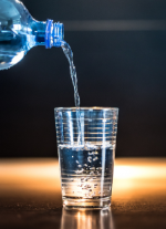 Glass Half Full Picture of glass being filled by water bottle