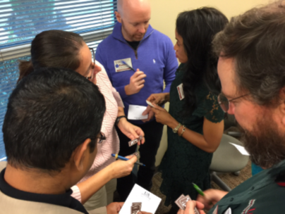 LeadAR participants working as a team group of people talking and writing on notepads