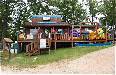 Cabin with floats and canoes on porch