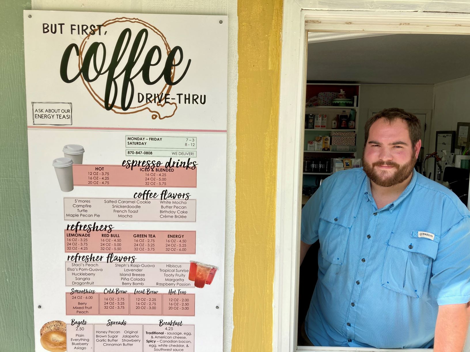 Man in retail store window next to sign that says But Coffee First