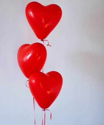 3 red heart shaped balloons