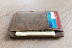 brown leather wallet with money and credit cards