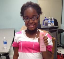 4-H girl holding ribbon