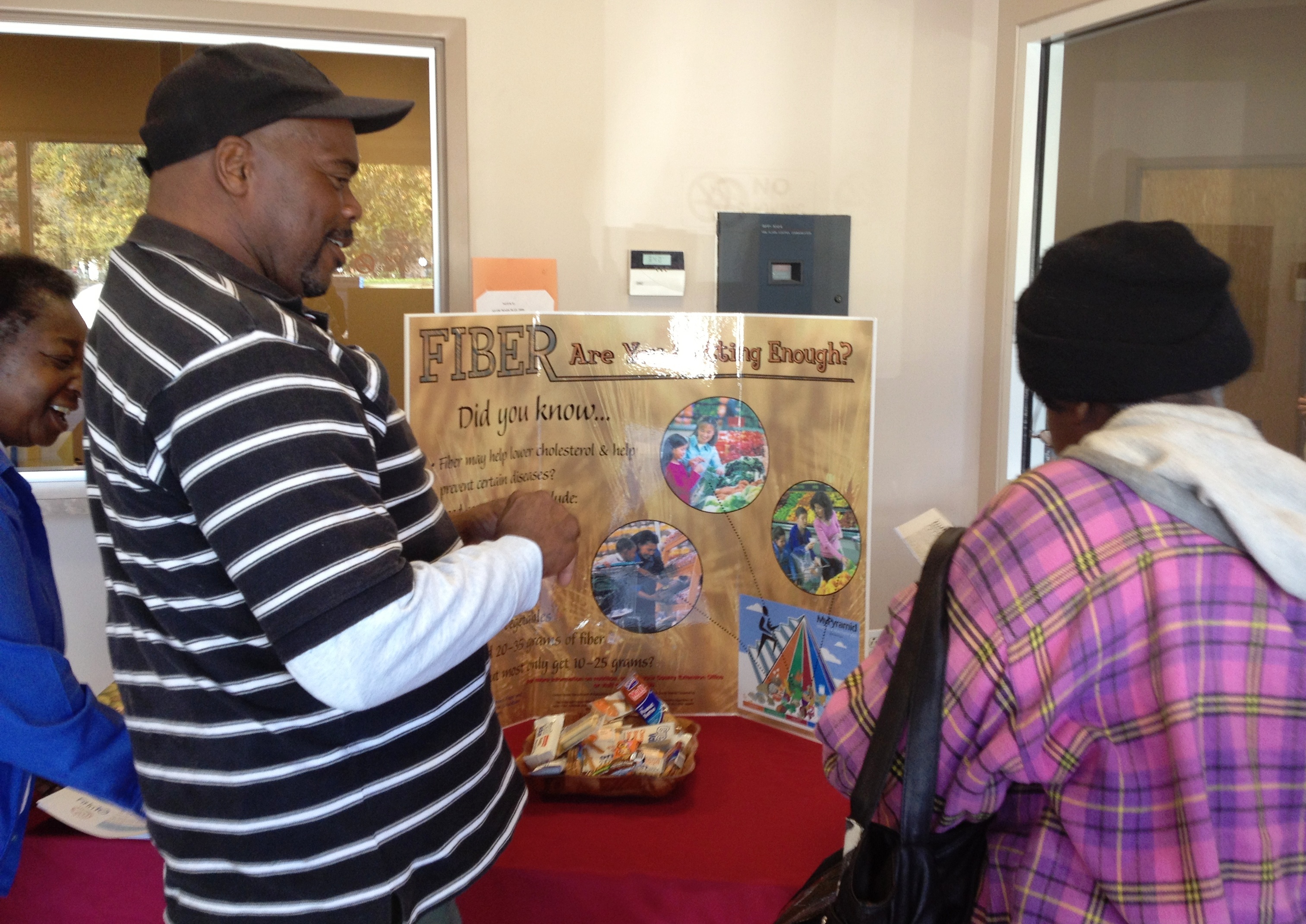 Two people viewing a whole grain exhibit