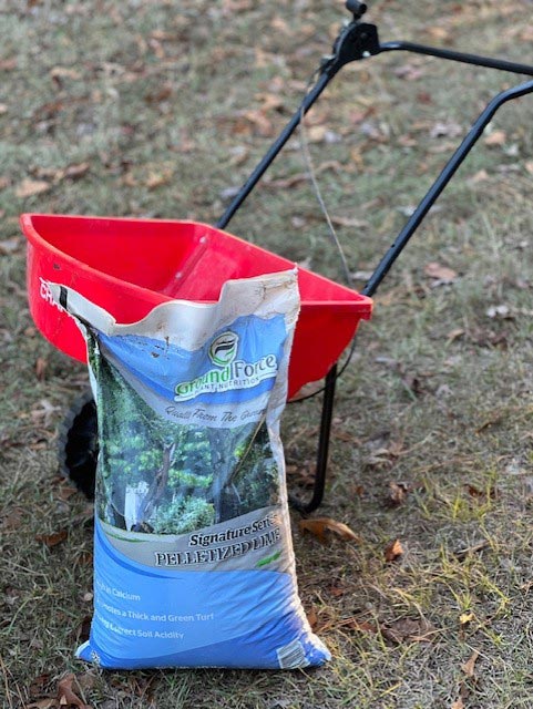 Lime bag and a spreader