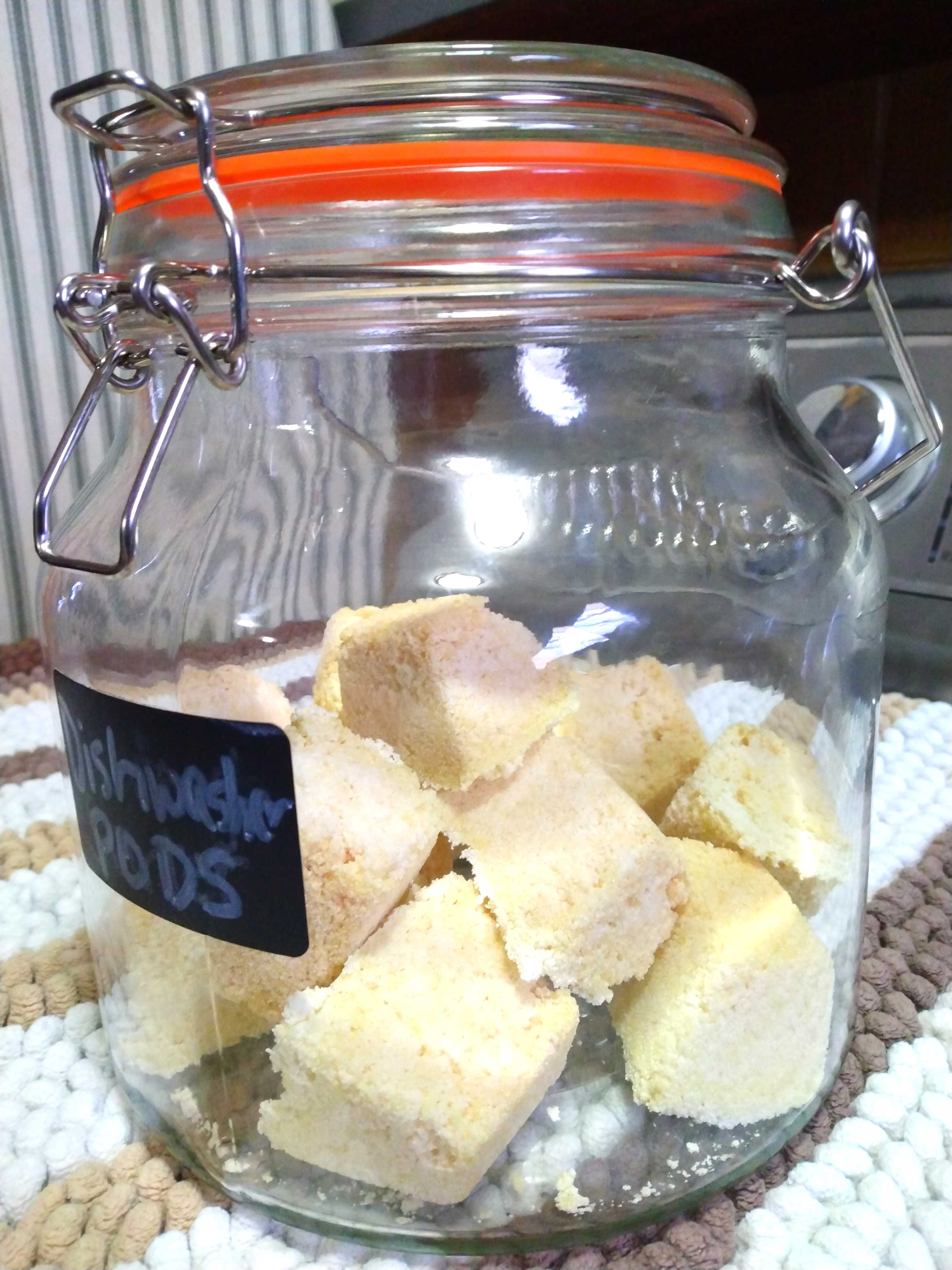jar with small beige cubes which are homemade dishwasher pods