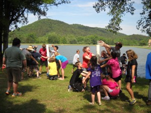 Children at lake preparing for Cardboard boat race