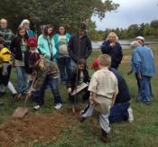 Master Gardeners and youth digging in ground at one day of service