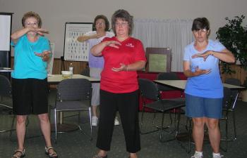 Four women doing Tai Chi exercises