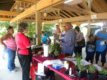 County agent explaining cooking demonstration to group of people