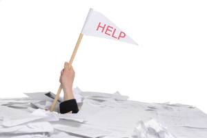 arm sticking out of mound of white papers. Hand holding a white flag with red words "Help".