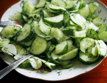 cucumber salad. cucumbers roughly chopped sprinkled with dill and drizzeld with vinaigrette