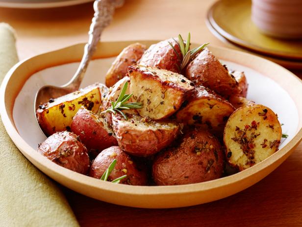plate of rosemary roasted red potatoes with a fork