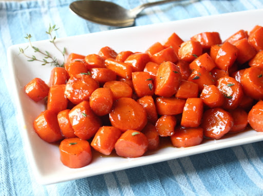 glazed carrots on a white dish