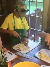 4-Her practicing knife skills at Quad County Camp