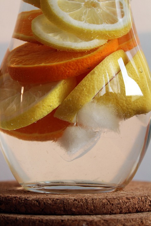 pitcher of water with oranges and lemons