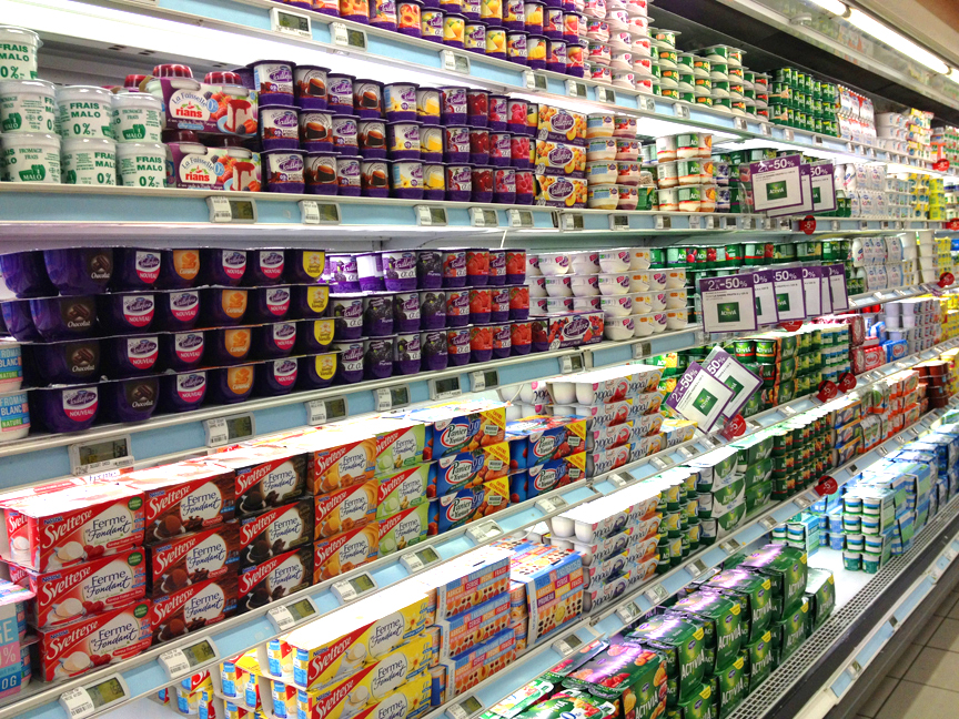 aisle in supermarket filled with yogurt varieties