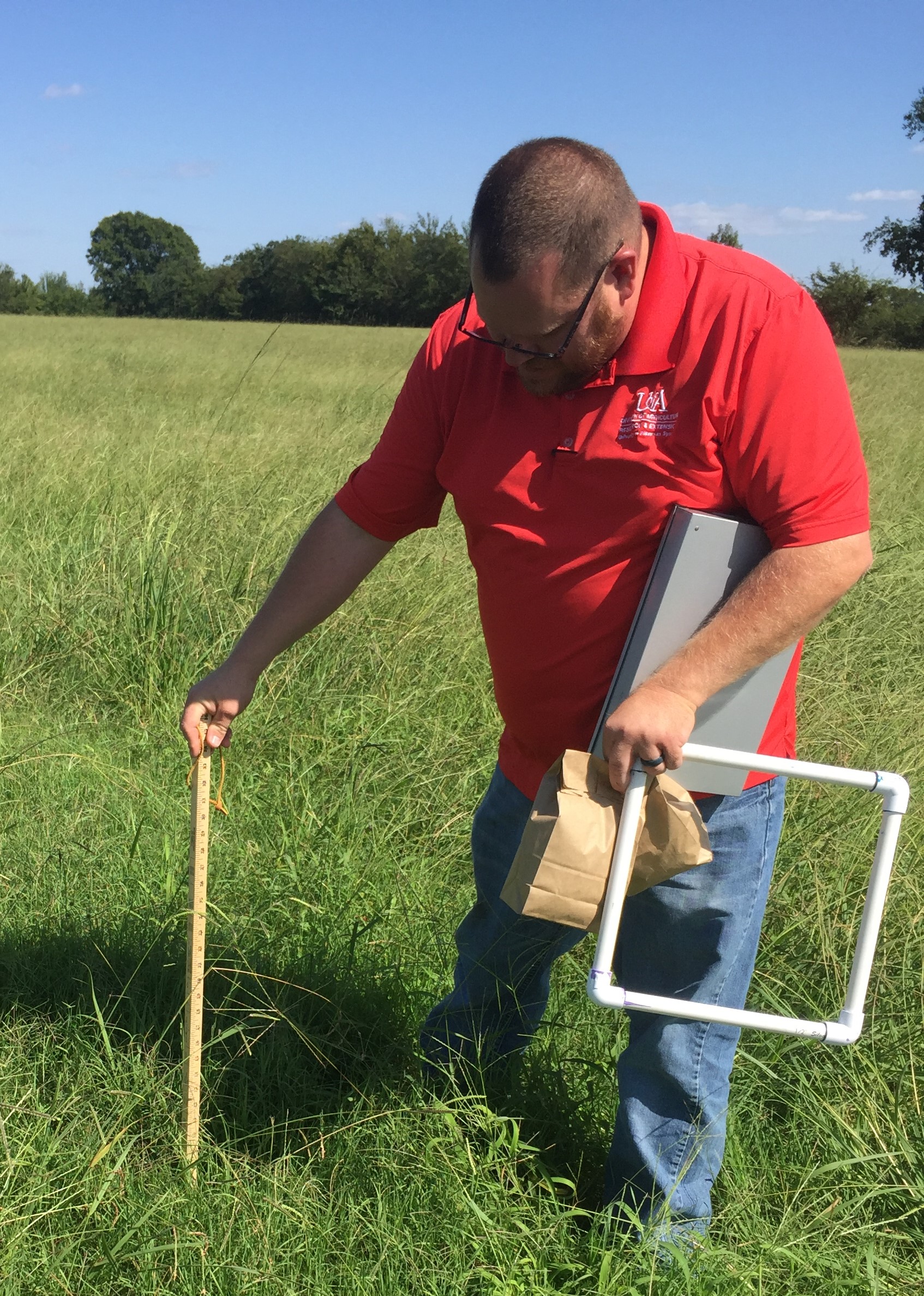 Ag Agent Terrell Davis measuring forage yeild for a demo