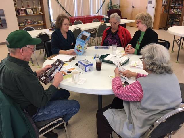 Harrisburg Senior Center participants analyze food labels while learning to reduce added sugar intake.