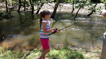 Girl fishing at 2015 Cloverbud / Jr Day Camp