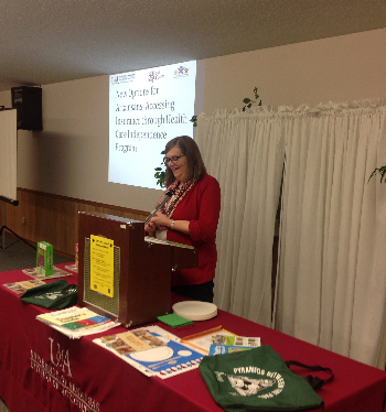 County Extension Agent Janet Cantrell standing behind podium teaching Best Care class