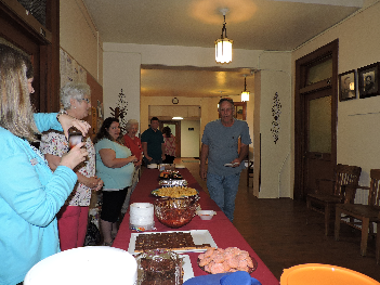 People standing behind a table serving food