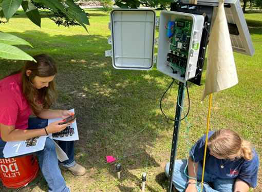 two people recording data from telemetric units