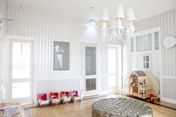 Gray and white daycare room with toys