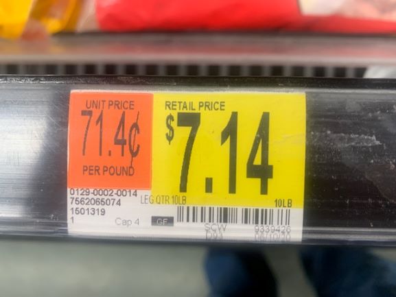 price tag on grocery store shelf for chicken leg quarters $7.14